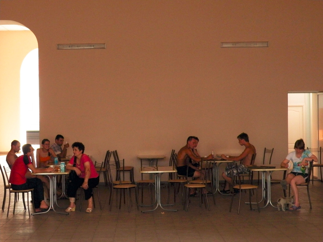 Passengers relax in a railroad station cafe