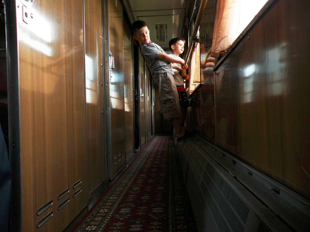 Children in the aisle of a sleeper car