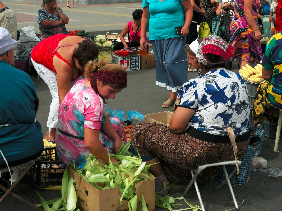Women selling corn at a railroad-side market